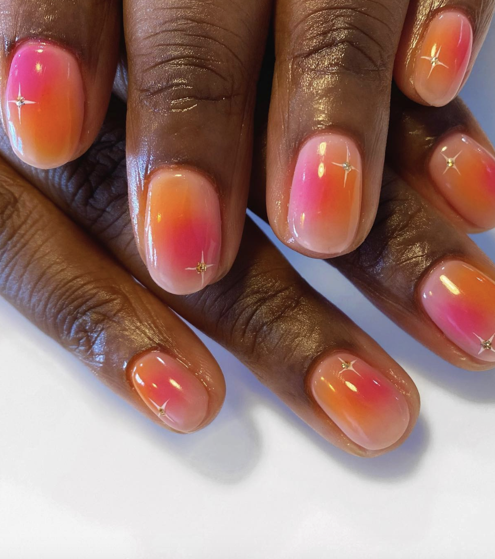 Orange and pink ombre nails with stars