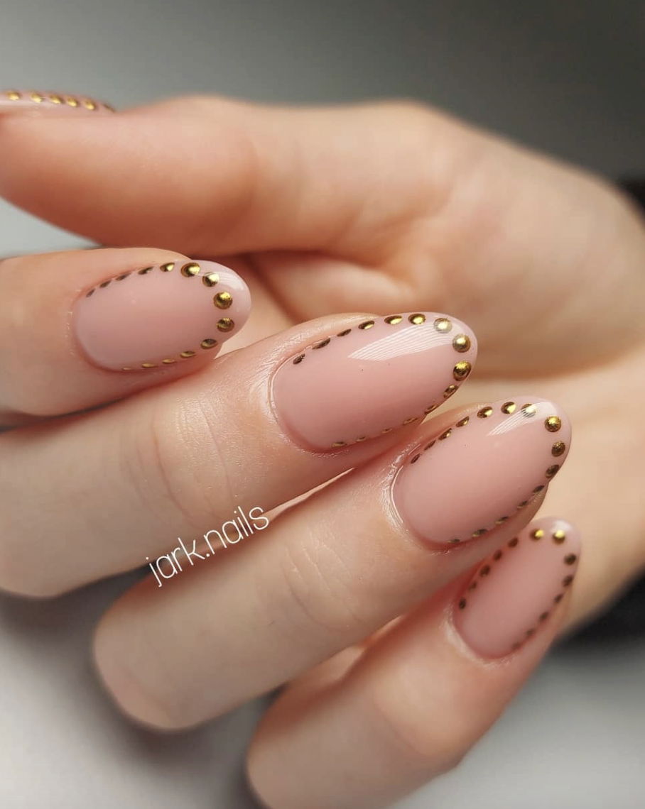 Metallic gold polka dot French tip nails