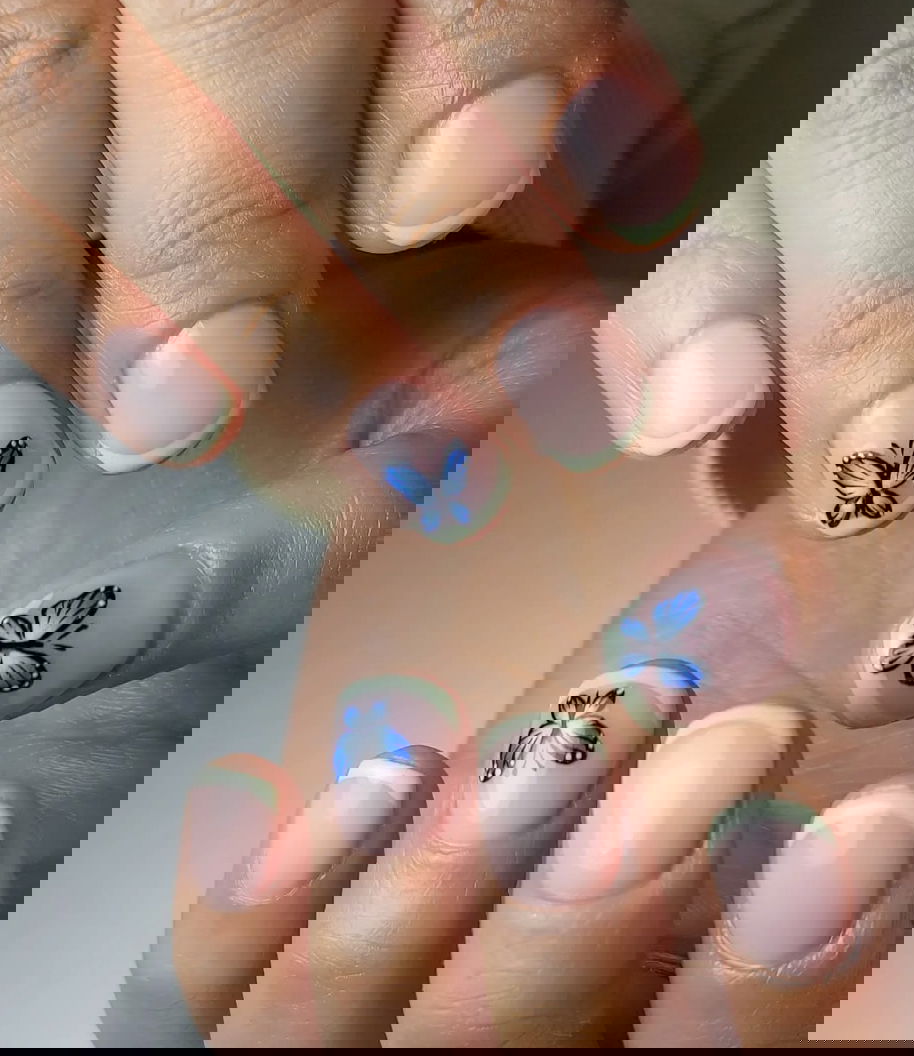 Mint green French tips with butterflies