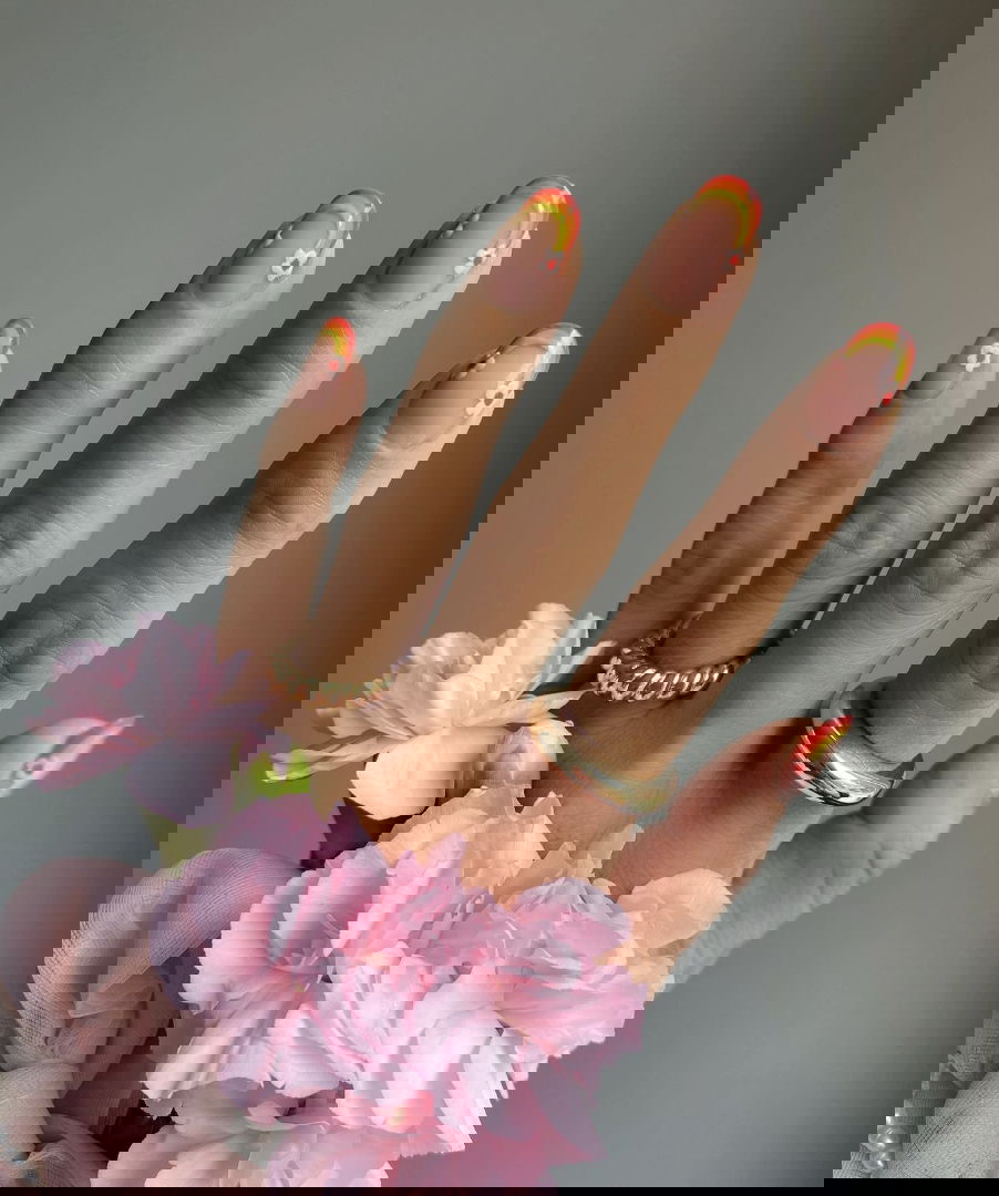 Rainbow French tip nails with flowers