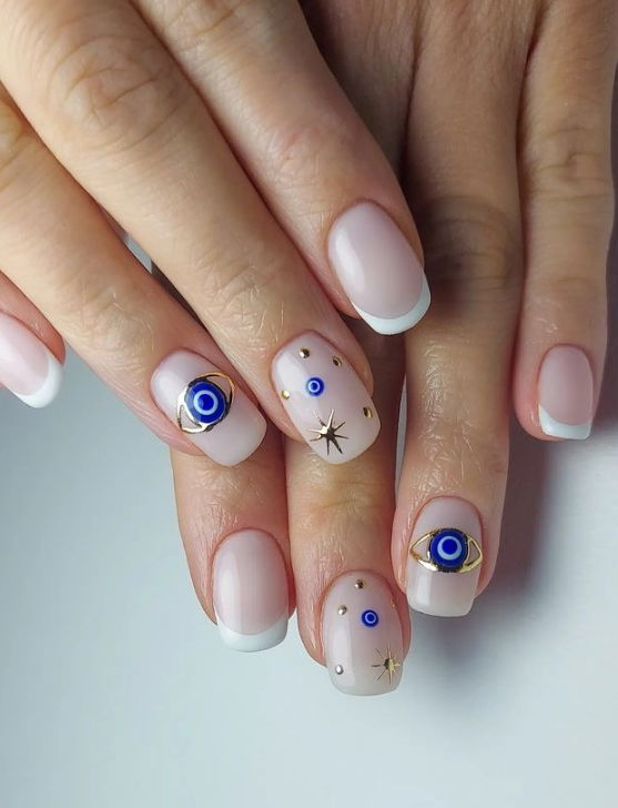 milky nude nails with evil eye
