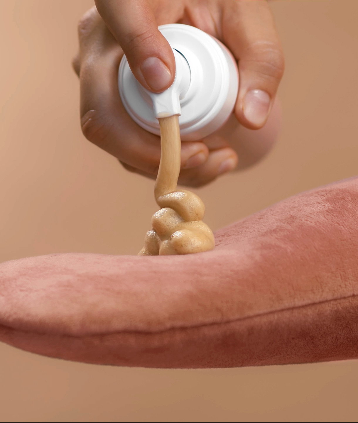Applying self-tanner mousse to a rose massage glove Ready to use High quality studio photo image beige background | Live That Glow How to Clean Your Tanning Mitt (for Glowing Tan Application)