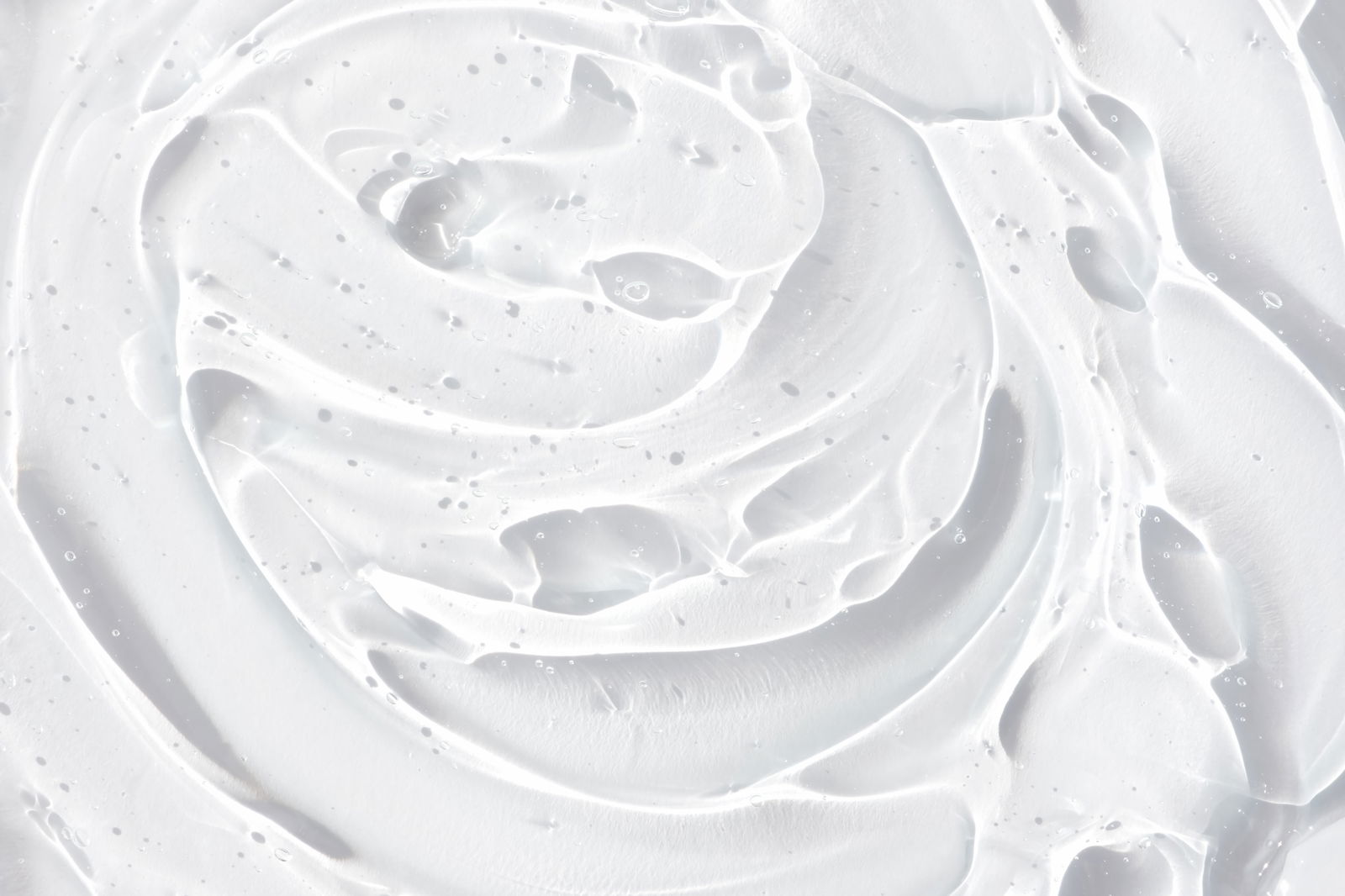 Transparent serum or gel with hyaluronic acid for the face. Textured background with oxygen bubbles. Wellness and beauty concept. Botox face