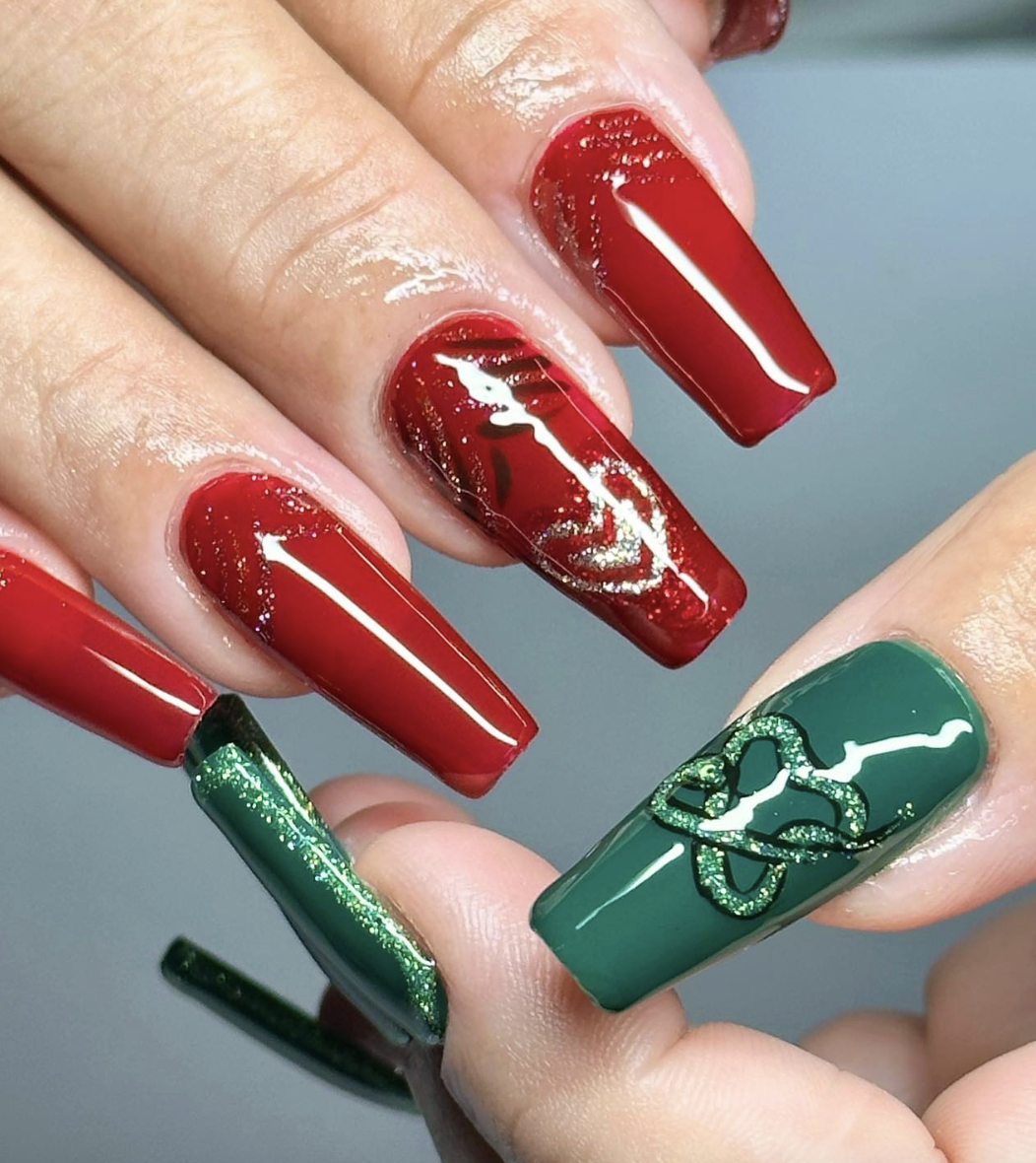 High-shine red and green coffin nails with glitter nail art