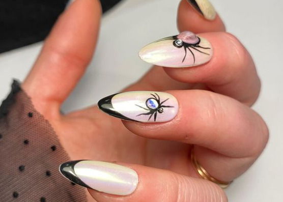 black french tip nails with bug rhinestones