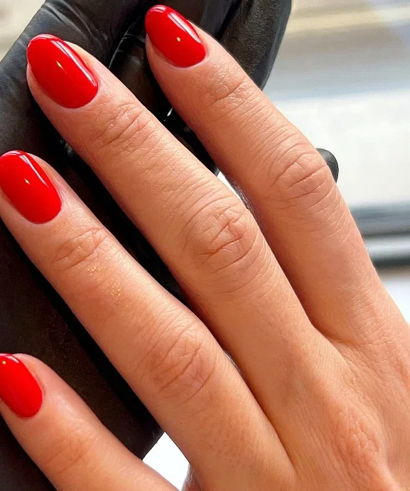 Bold glossy red on oval nails