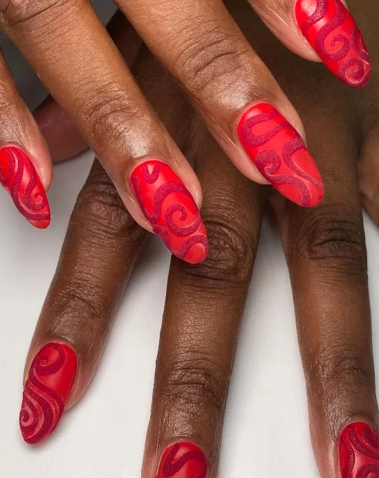 Long matte red nails with swirls