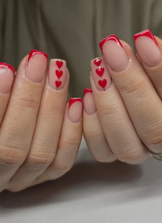 Red square nails with heart detail and French tips