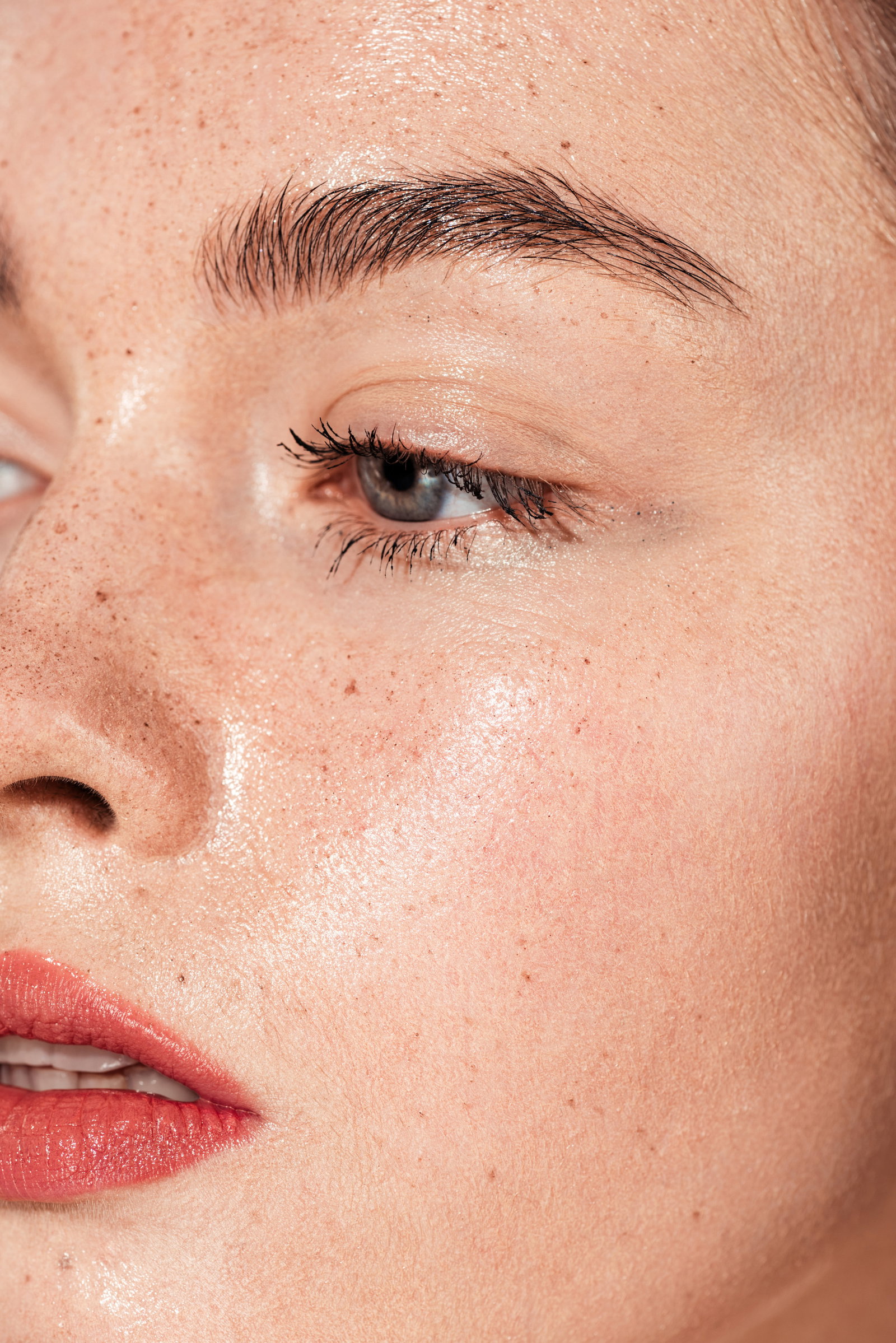 close up of young woman with coral lips and wet skin | Live That Glow