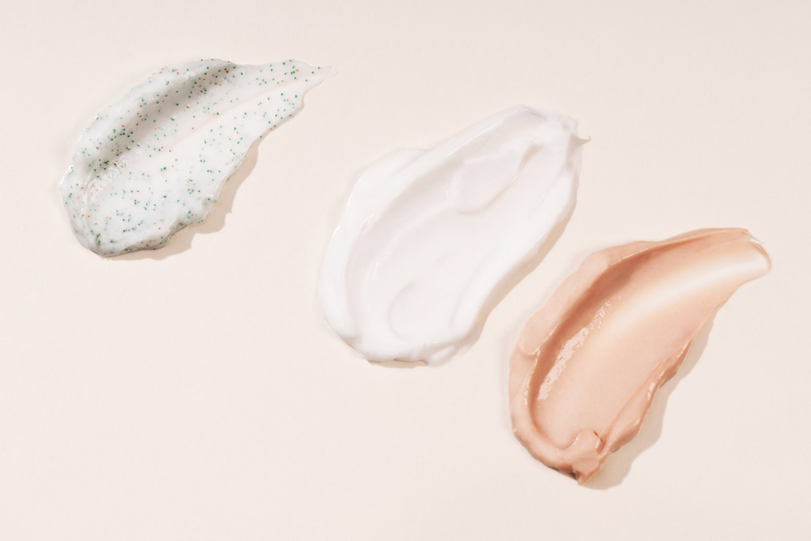 Cosmetic smears of creamy texture on a pastel beige background Cosmetic background cream care product | Live That Glow