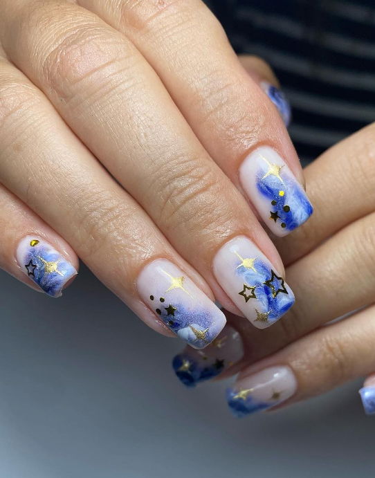 Milky white square nails with marble clouds and gold stars