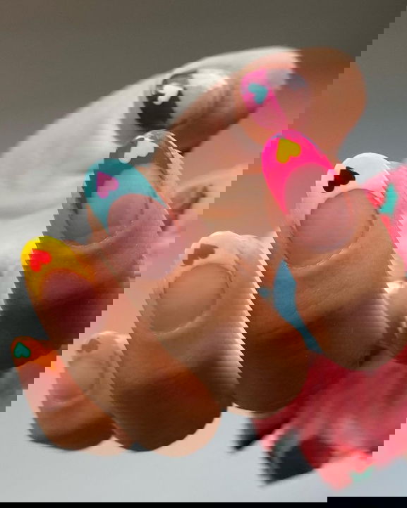 bright French tip nails with hearts hang