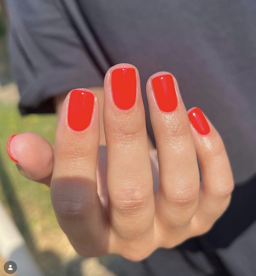 bright-neon-orange-nails-claire-stark | Live That Glow Short square nails painted in glossy bright neon orange