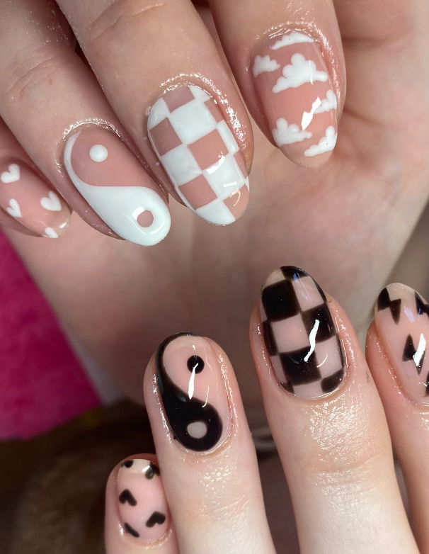 clear nails with mimsmatched designs and clouds and lightning bolts