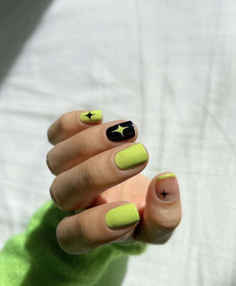 green-neon-star-nails | Live That Glow Short neon green and black nails with contrasting star nail art