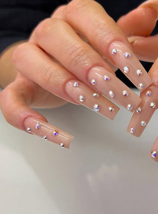 long nude acrylic nails with gems
