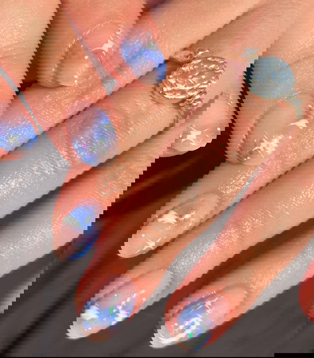 https://www.livethatglow.com/wp-content/uploads/2024/01/natural-nails-with-blue-clouds-and-sparkles.jpg?utm_source=chatgpt.com