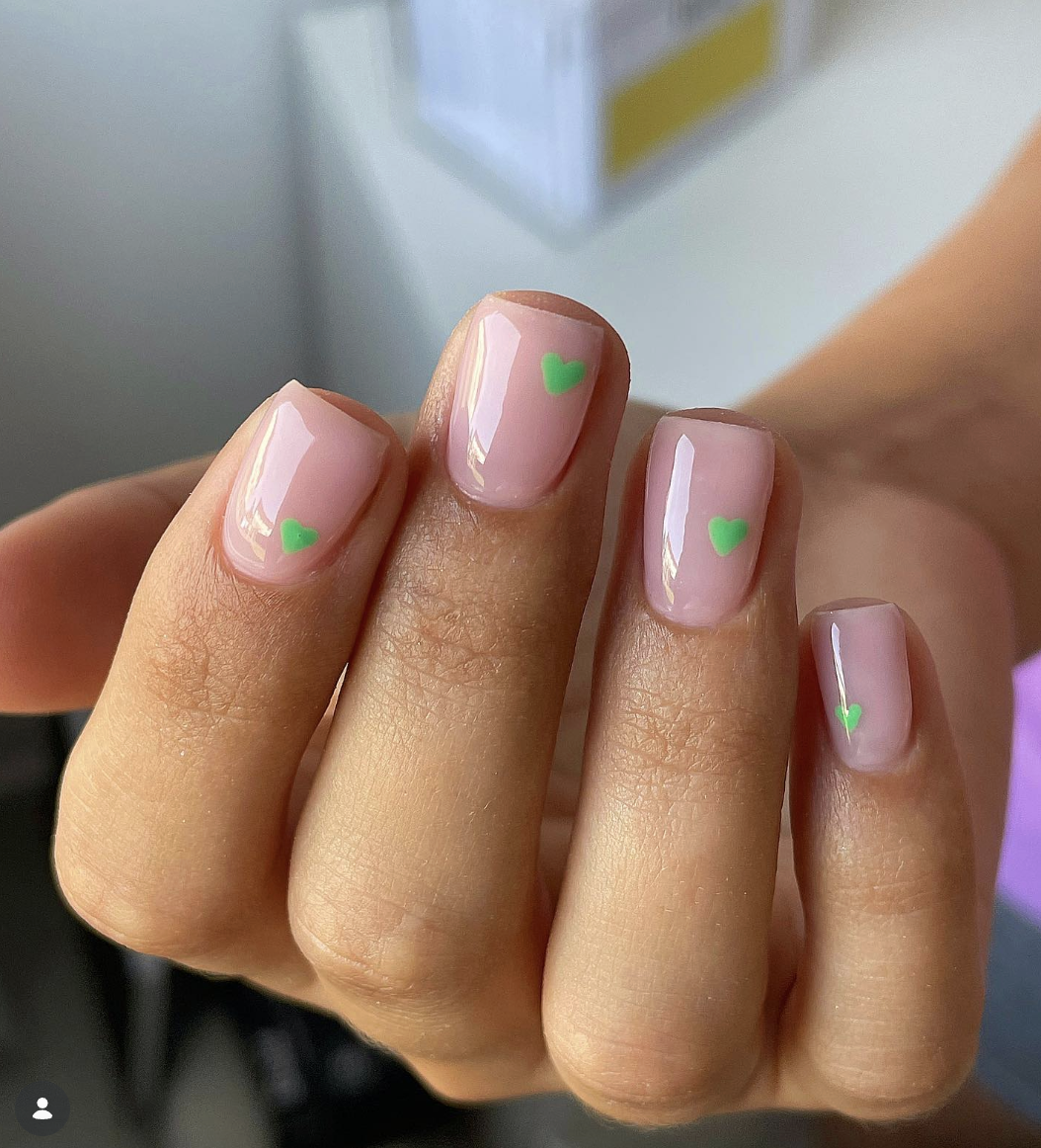 neon-green-heart-nails-claire-stark | Live That Glow Short glossy nude nails with tiny neon green heart nail art