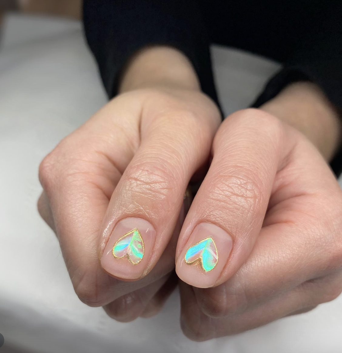 neon-holographic-heart-nails | Live That Glow Short natural nails with holographic heart nail art and gold chrome edging