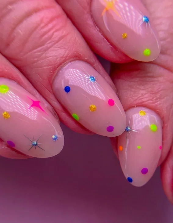 neon-polka-dot-nails | Live That Glow Sheer nude almond nails with colourful neon polka dots and sparkling star details