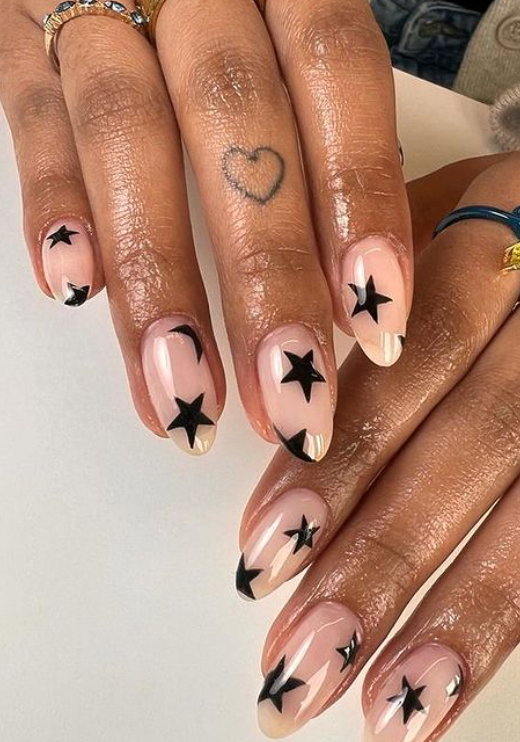 nude almond nails with black stars