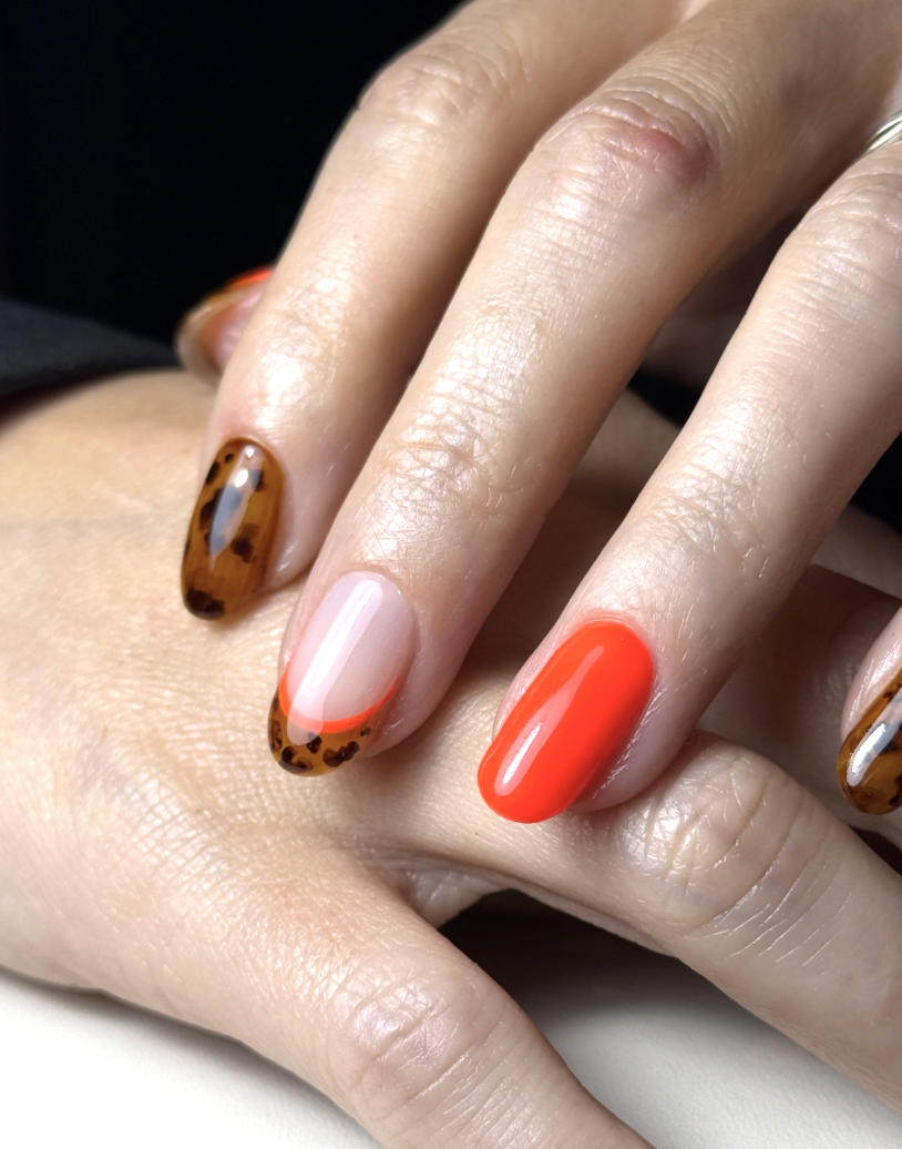 orange-neon-tortoiseshell-nails | Live That Glow Glossy orange neon nails with tortoiseshell nail art and French tip detail