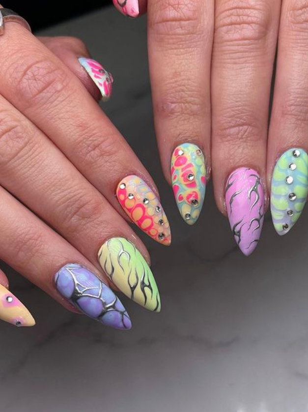 pastel rainbow nails with intricate designs and silver details