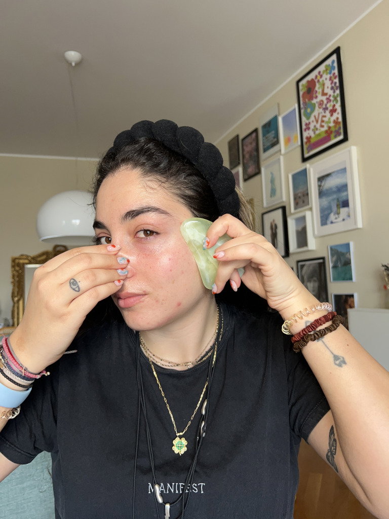 prep-step2- | Live That Glow Journalist Fani Mari shows how to use a gua sha on your cheeks