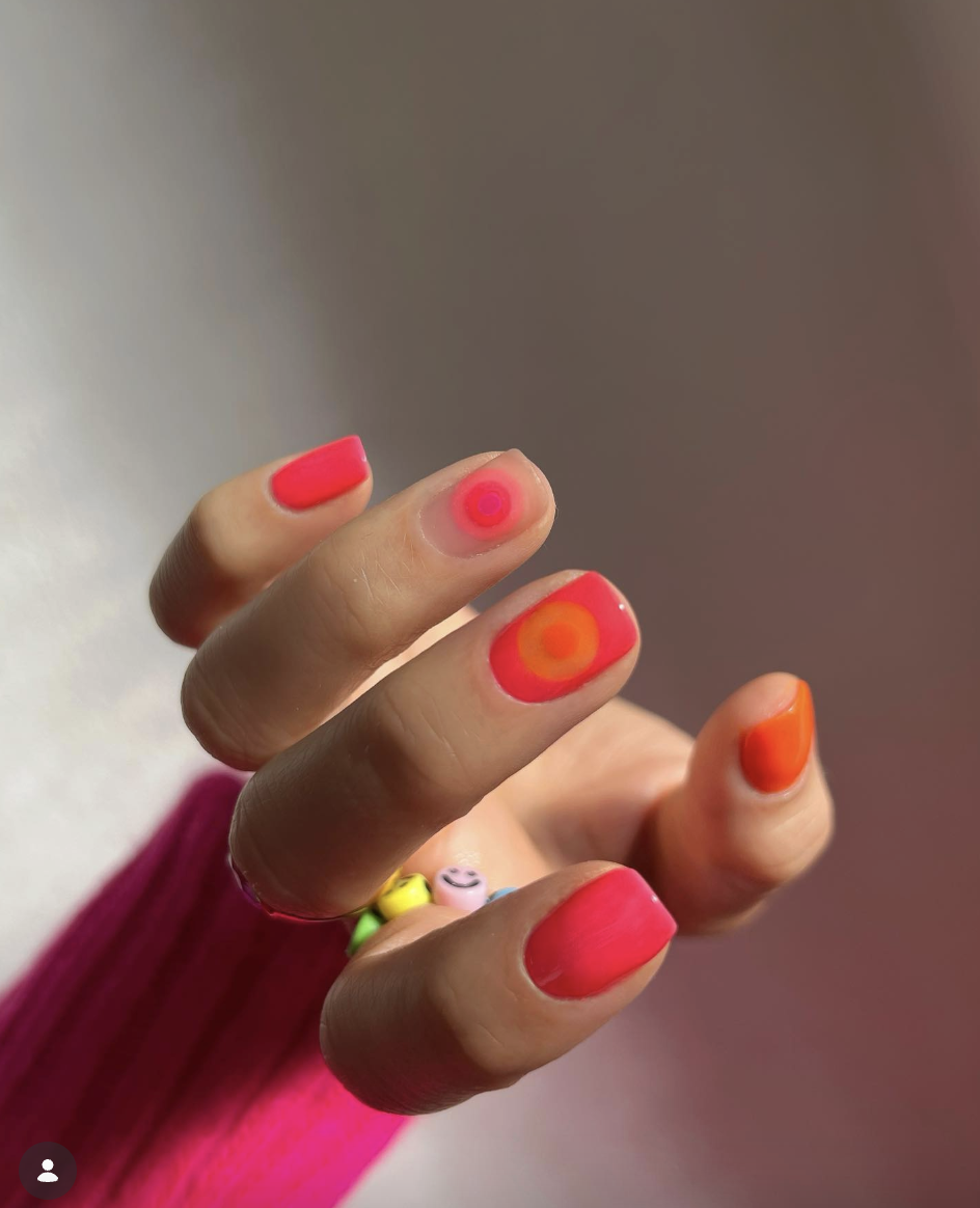tropical-pink-orange-neon-nails-the-hang-edit | Live That Glow Short bright pink and orange neon nails with circular aura-style nail art