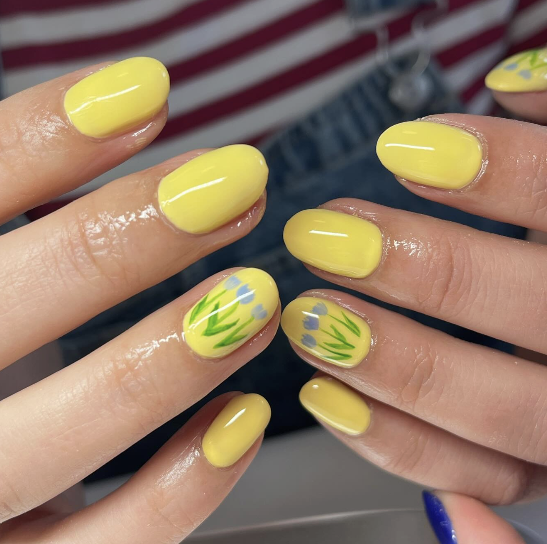 yellow-neon-floral-nails | Live That Glow Glossy yellow neon nails with delicate blue tulip nail art