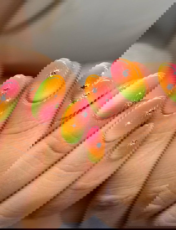 yellow orange and pink ombre nails with gems
