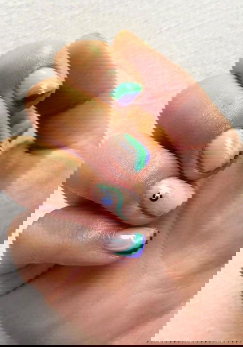 blue swirl nails with evil eye