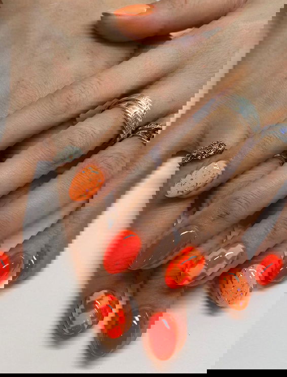 mismatched neon orange nails with checkered print