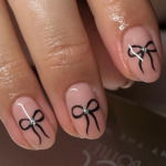 nude nails with black bows and silver gems