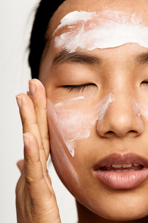 Beautiful young asian woman applying cream | Live That Glow
