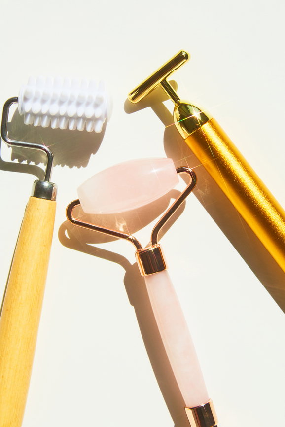 Facial rollers over white background Beauty tool shot | Live That Glow