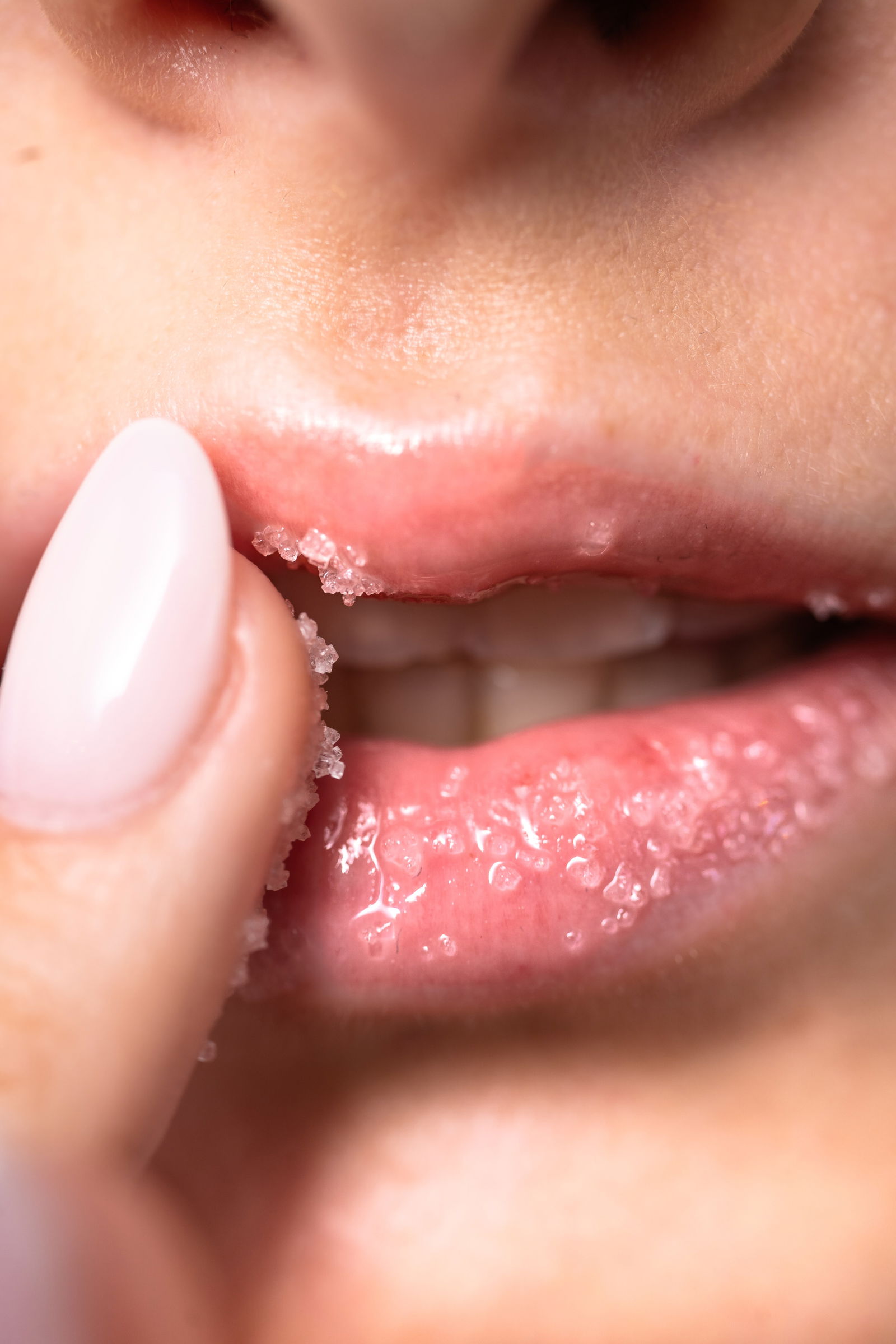 Woman showing how to use lip scrub