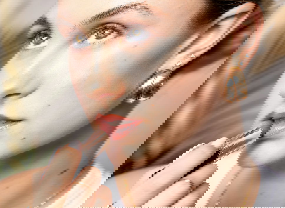 Woman showing how to apply lipstick