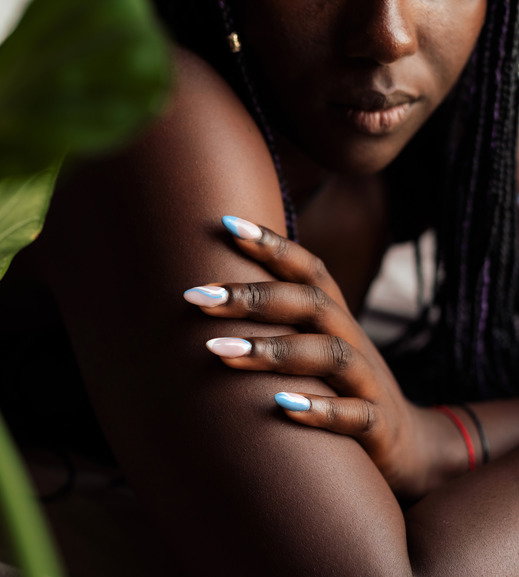 Black woman's hand and fingers with manicure and colorful nails dip powder nails