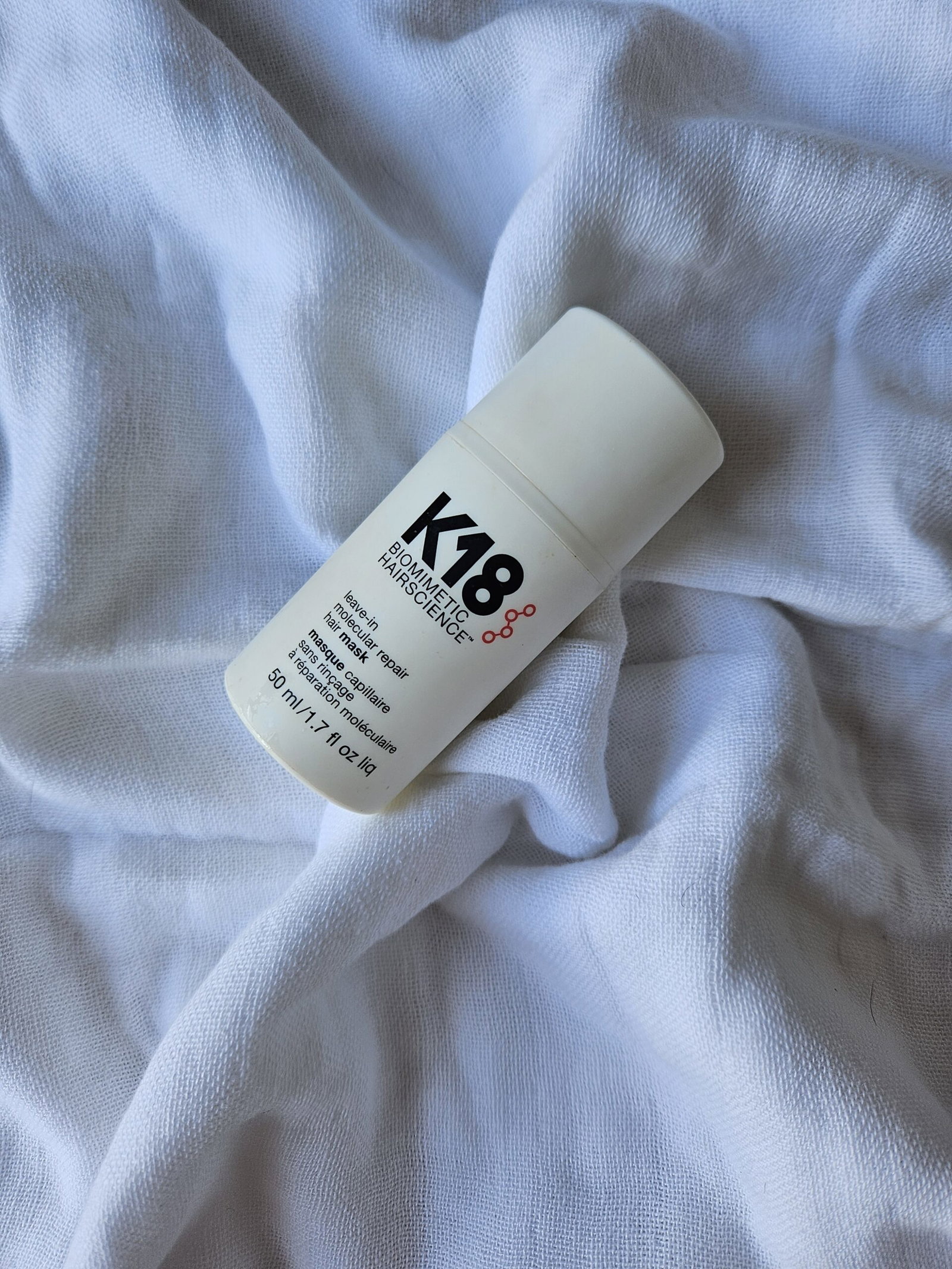 K18 Leave-In Molecular Repair Hair Mask 50ml bottle photographed on white fabric