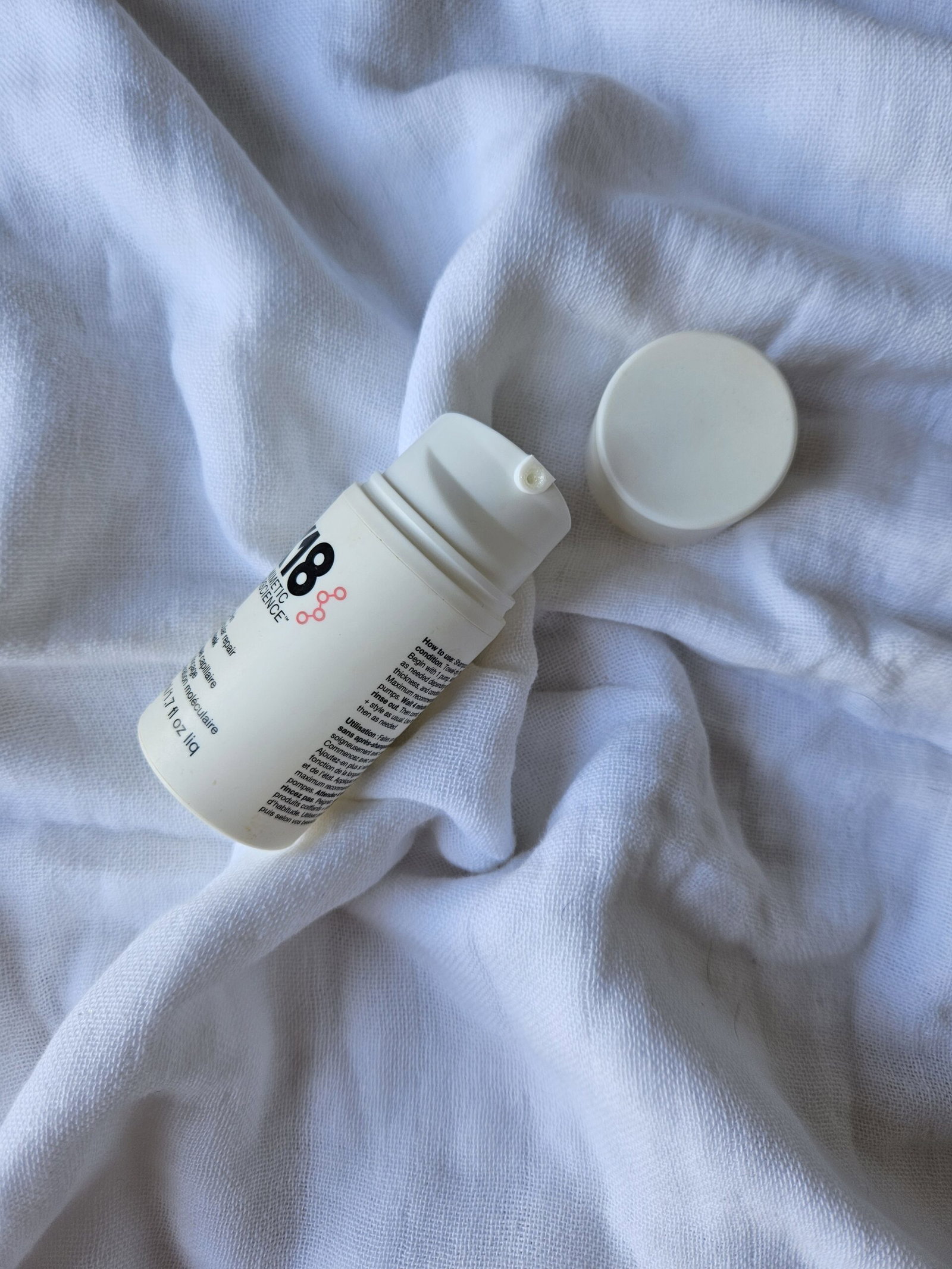 K18 Leave-In Molecular Repair Hair Mask bottle with the pump dispenser open