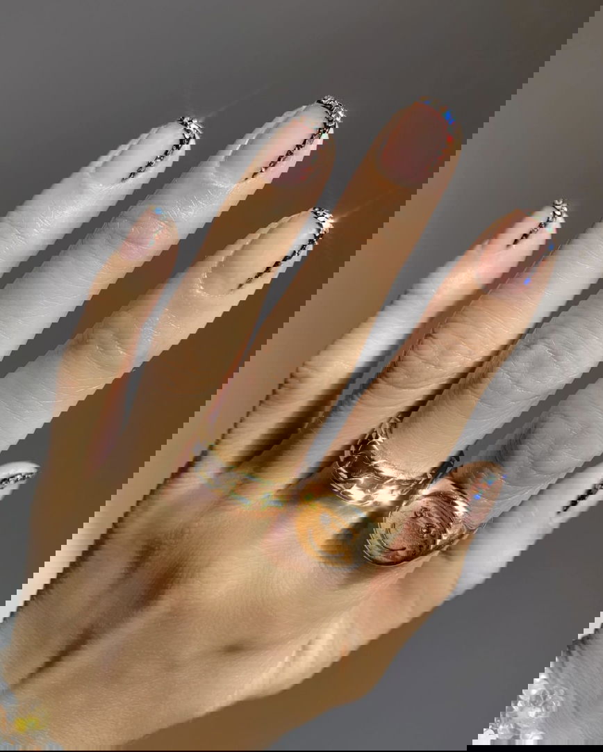 French tip nails with Christmas jewels