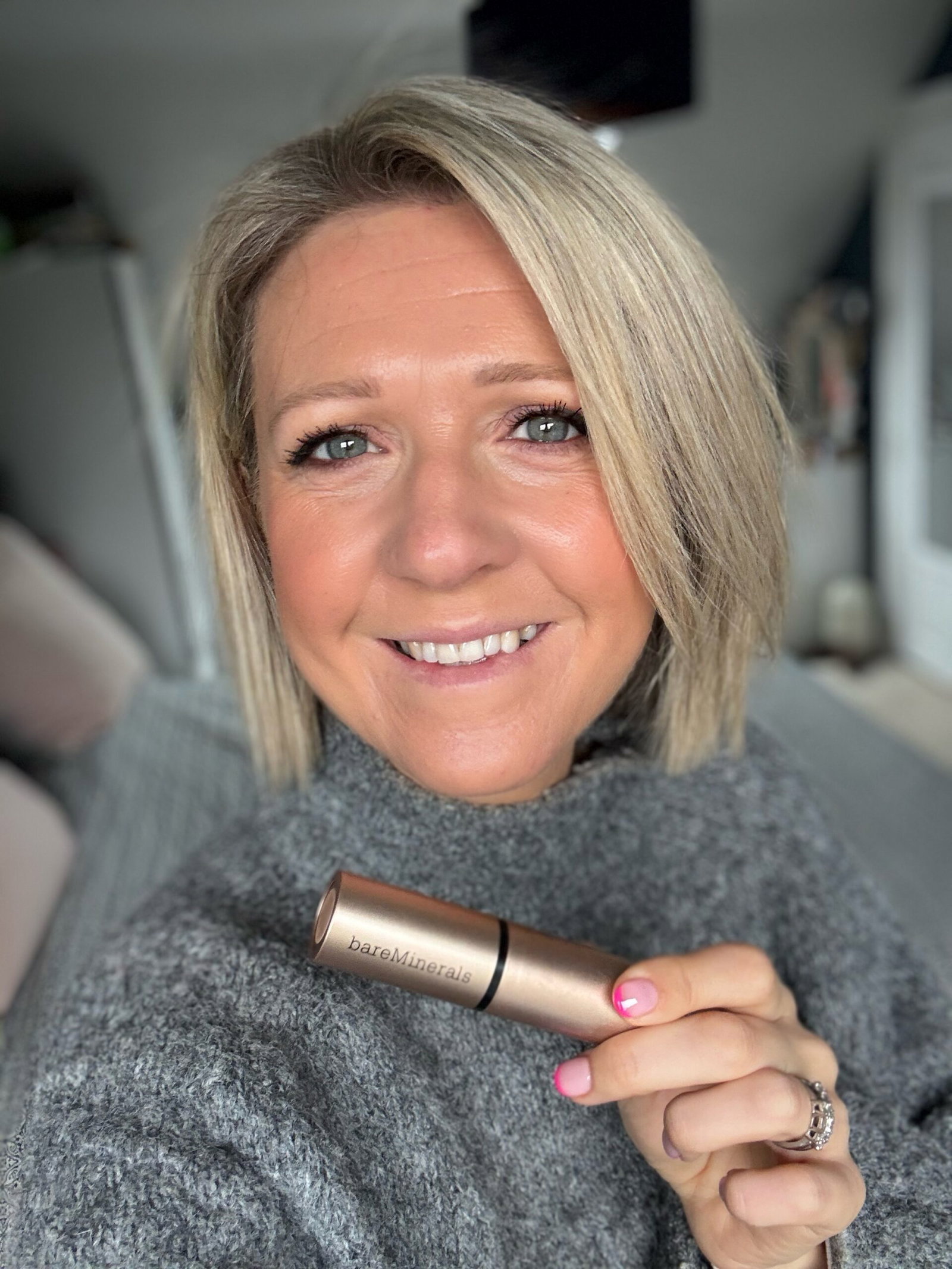 Woman after applying BareMinerals Complexion Rescue Luminous Skin Tint Stick