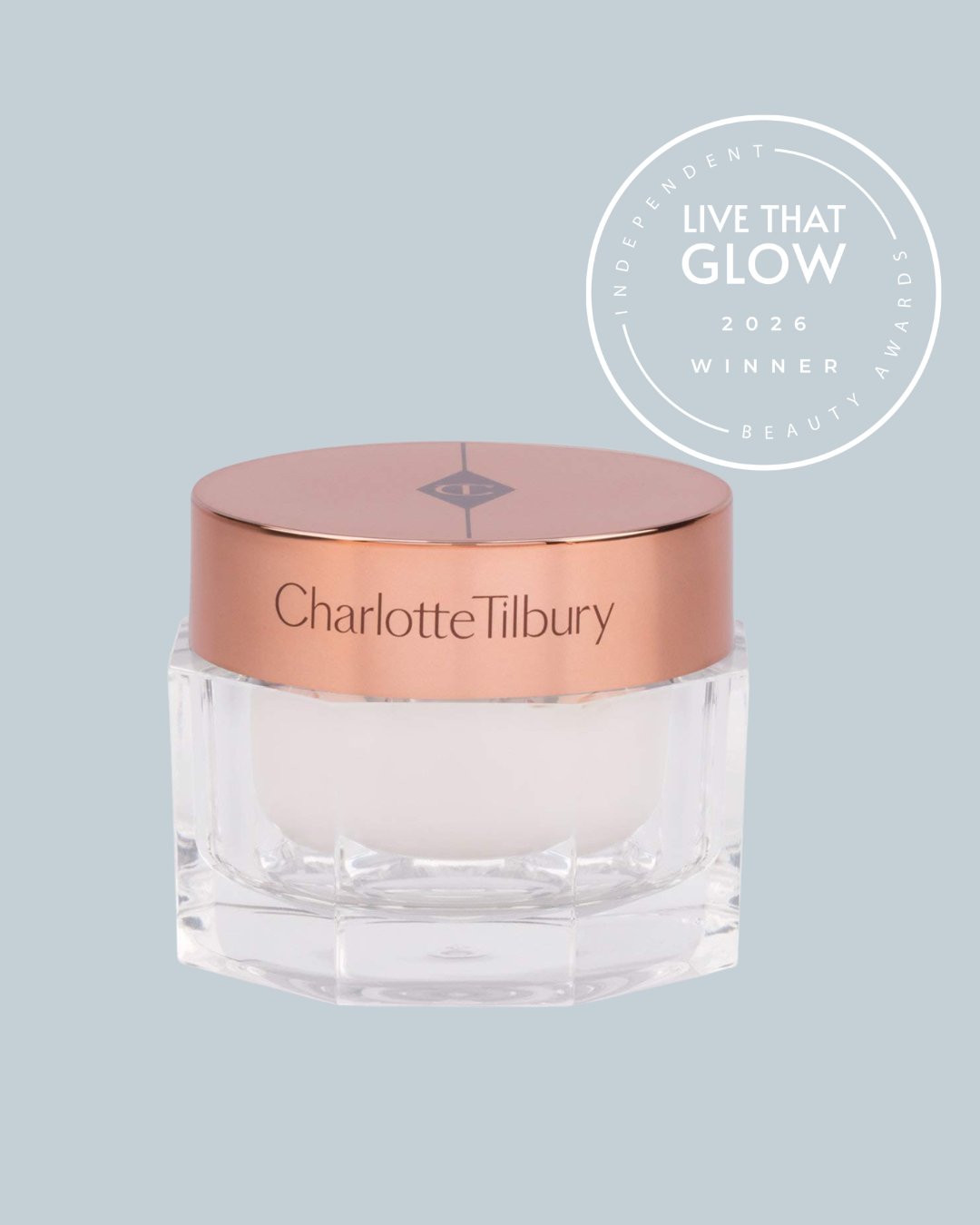 Live That Glow Independent Beauty Awards 2026 Readers Choice Award 2026 winner - Charlotte Tilbury Magic Cream | Live That Glow Charlotte Tilbury cosmetic jar with pink-gold lid on a pale blue background, plus a circular 'Live That Glow 2026 Winner' award badge to the right.