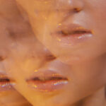 Abstract collage of peach?toned, close?up lips and facial features repeated across the frame in a warm, blurry pattern.