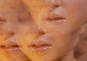 Abstract collage of peach?toned, close?up lips and facial features repeated across the frame in a warm, blurry pattern.
