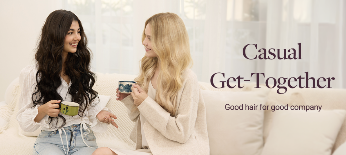 Two women sit on a sofa, converse with mugs in hand during a casual chat at home, warm and friendly vibe.