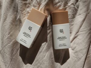 Beauty of Joseon Daily Tinted Fluid Sunscreen SPF 30 bottles showing two different tint shades