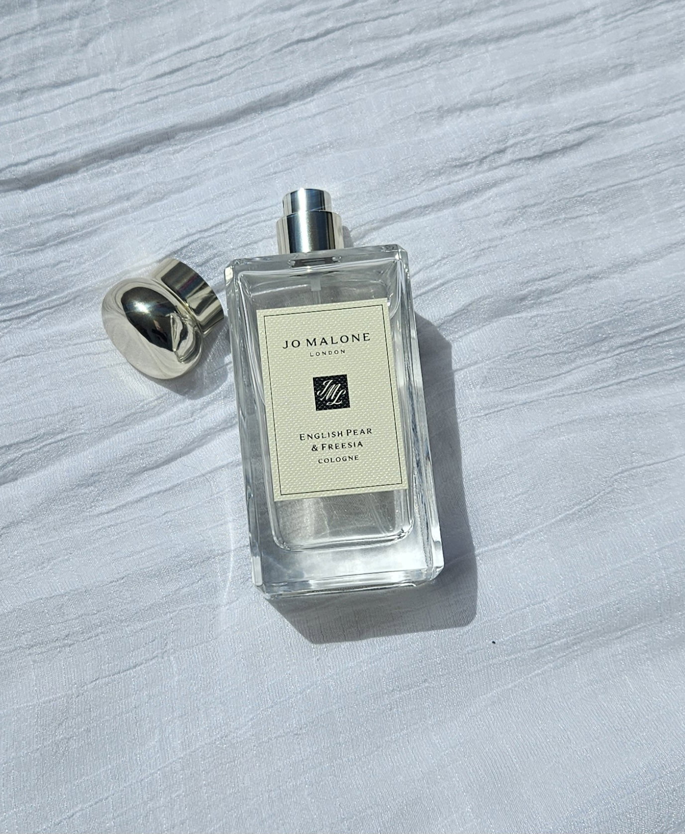 jo-malone-english-pear-freesia-cologne-bottle | Live That Glow Jo Malone London English Pear & Freesia Cologne bottle with the spray nozzle and cap visible