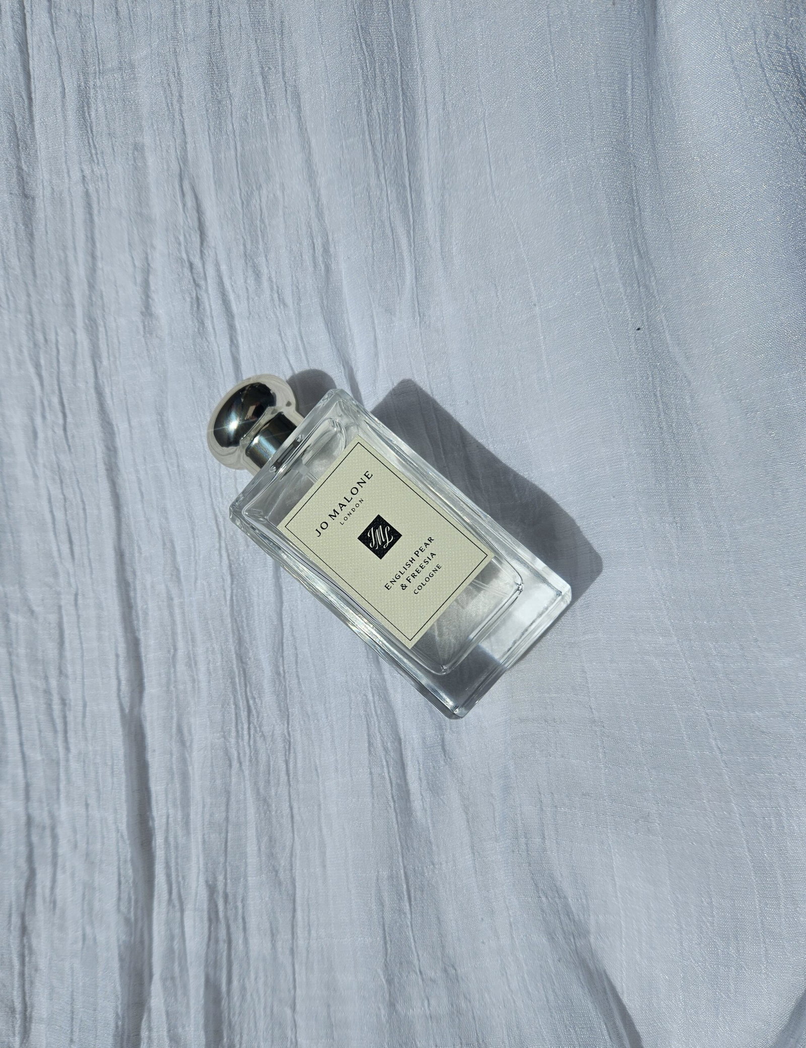jo-malone-english-pear-freesia-cologne-sunlight | Live That Glow Jo Malone London English Pear & Freesia Cologne bottle in natural sunlight